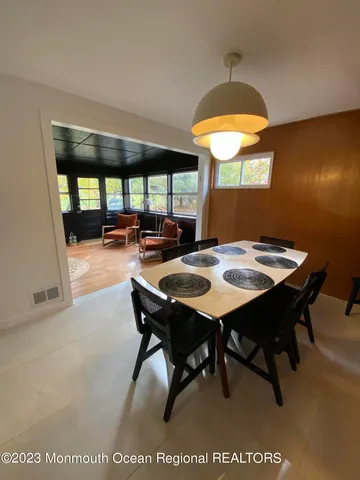 a view of a dining room with furniture and window