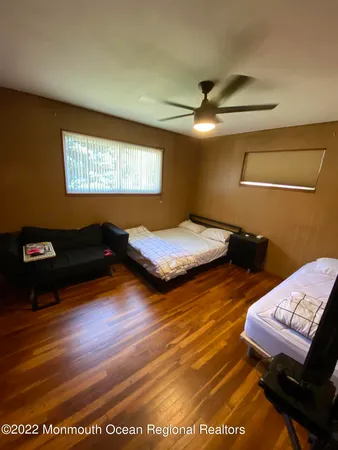 a bedroom with two beds and a desk