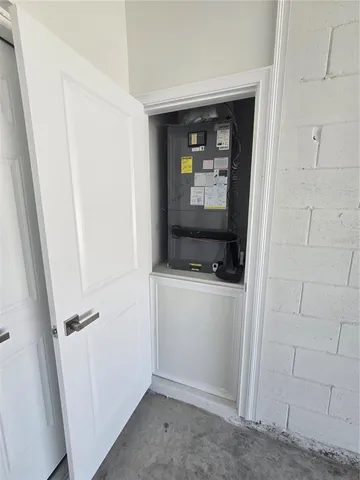 a room with a white cabinet and a white bed