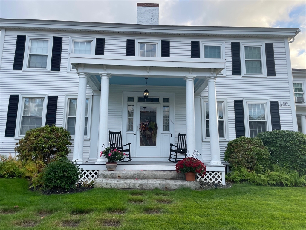 112 Main Street, Unit A Upton, MA 01568 - Photo 11 of 12 a front view of a house with a garden