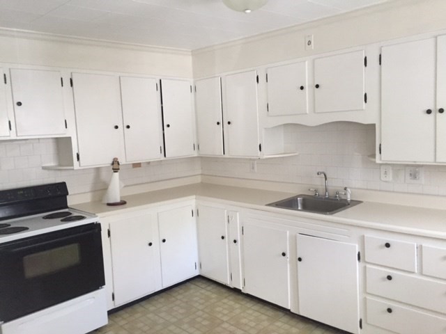 112 Main Street, Unit A Upton, MA 01568 - Photo 2 of 12 a kitchen with white cabinets and white appliances