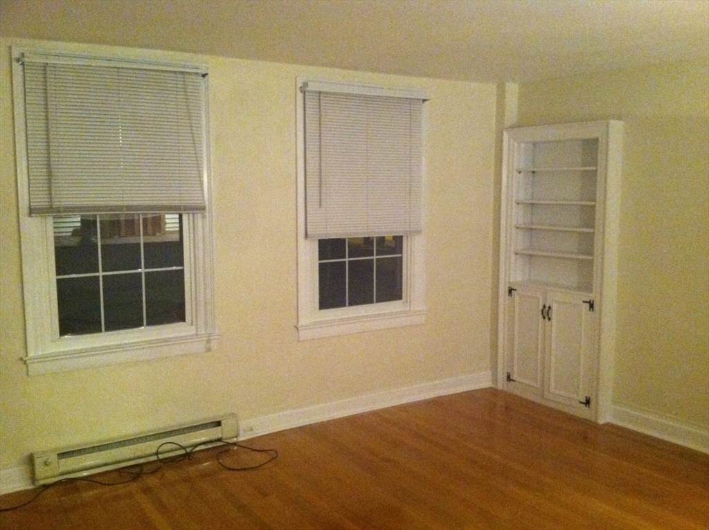 112 Main Street, Unit A Upton, MA 01568 - Photo 10 of 12 an empty room with a empty space and windows