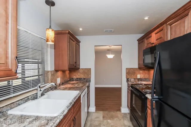 a kitchen with a sink stove and refrigerator
