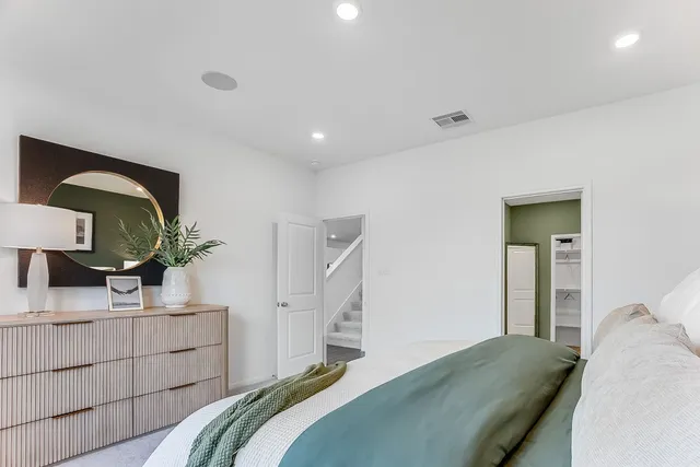 a spacious bedroom with a bed and a couch