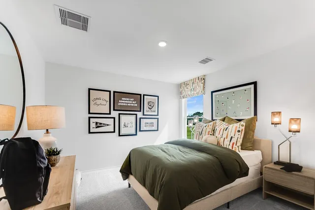 a bedroom with a bed and painting on the wall