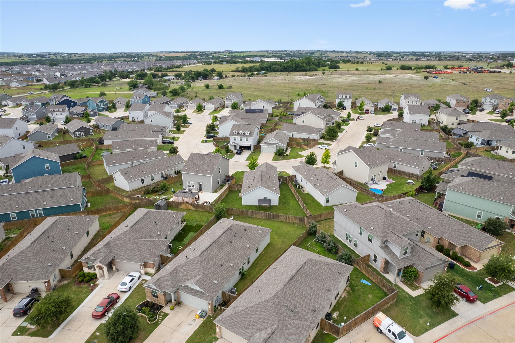 791 Circle Way Jarrell, TX 76537 - Photo 34 of 36 Aerial perspective showcasing a residential community with varied home styles and surrounding natural landscapes