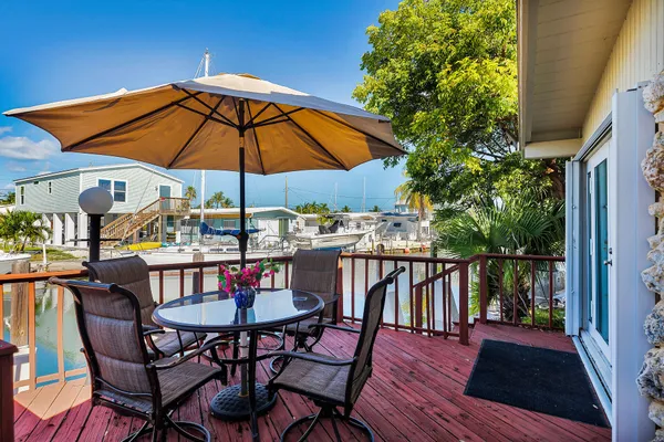a patio with a patio table and chairs