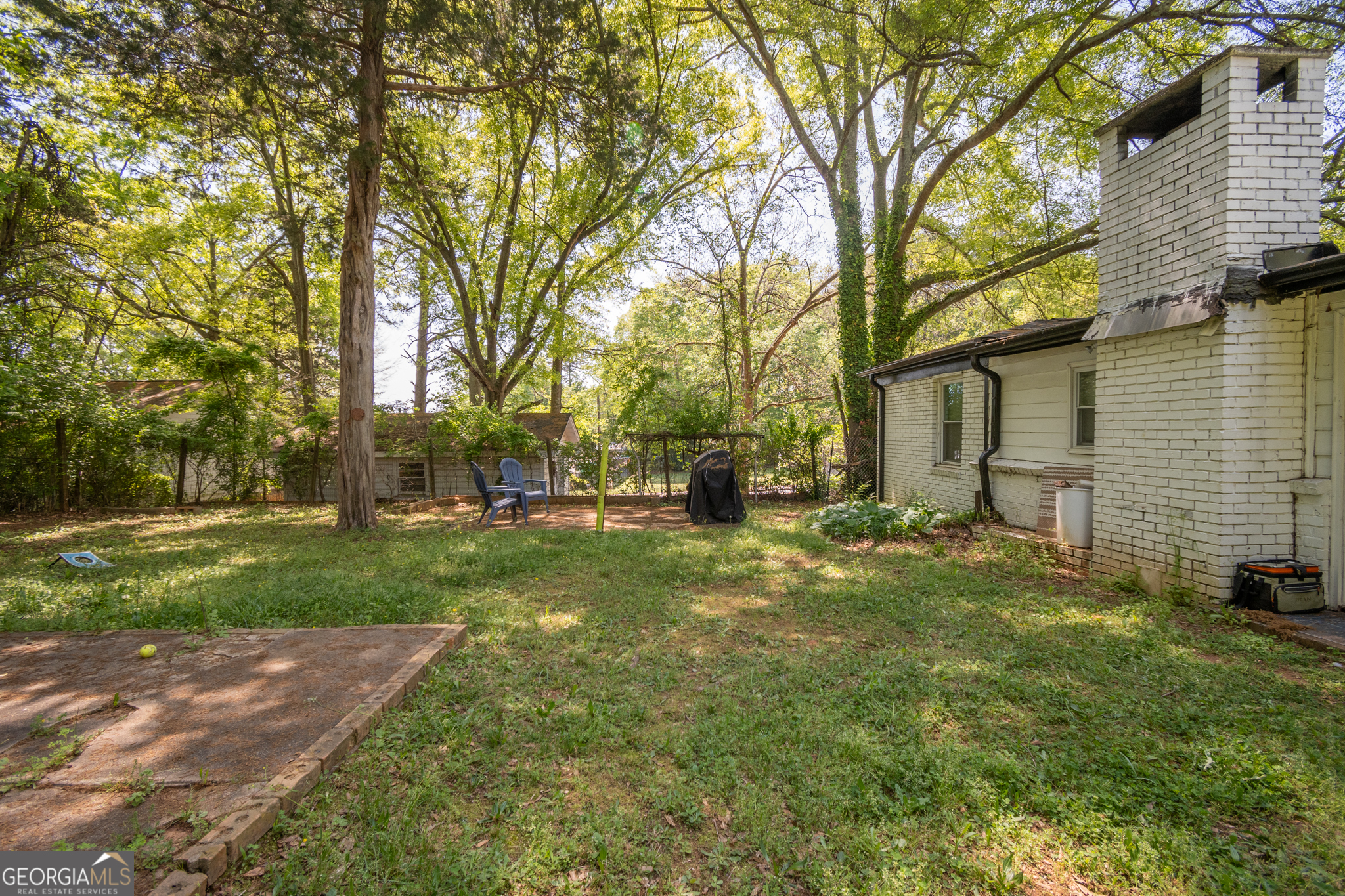 120 Hillside Street Athens, GA 30601 - Photo 14 of 18 a backyard of a house with plants and large tree