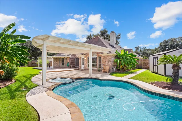 a view of a house with a backyard and a patio