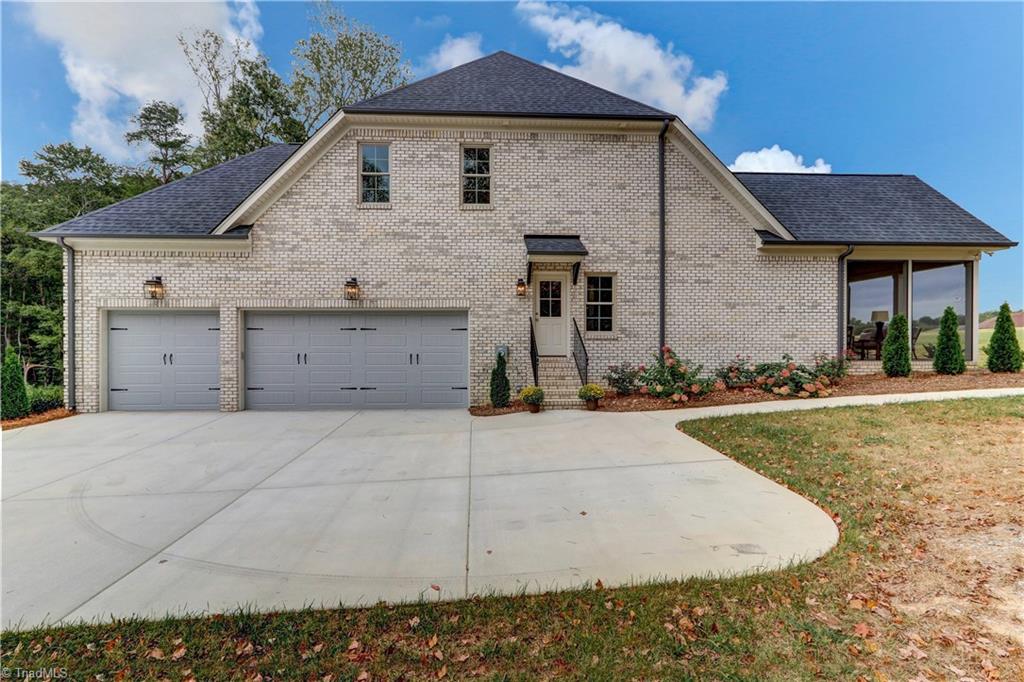 6861 Matzinger Court Oak Ridge, NC 27310 - Photo 29 of 30 Three Car Garage and view of the side of 6861 Matzinger Court