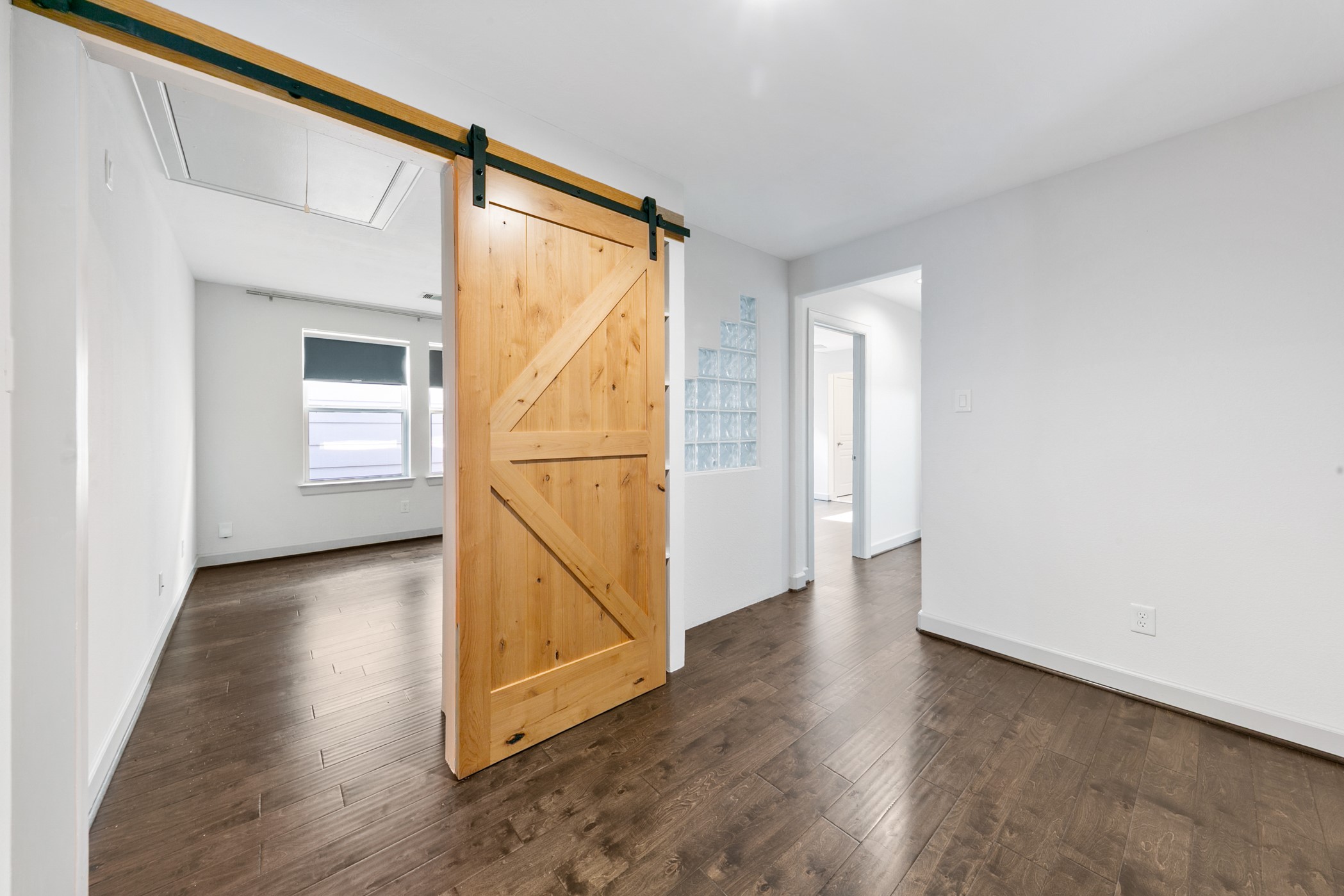 1809 Wichita Street Houston, TX 77004 - Photo 19 of 32 a view of an empty room with wooden floor and a window