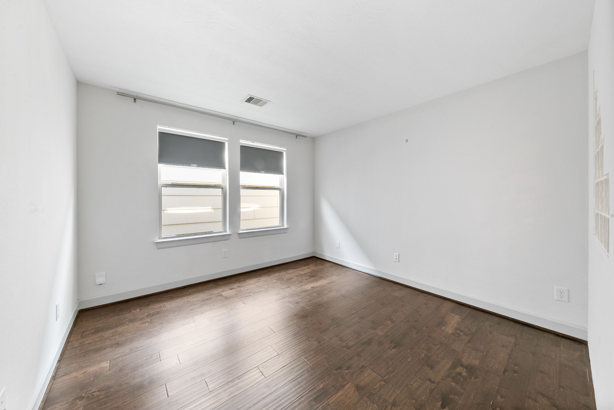 1809 Wichita Street Houston, TX 77004 - Photo 20 of 32 an empty room with wooden floor and windows