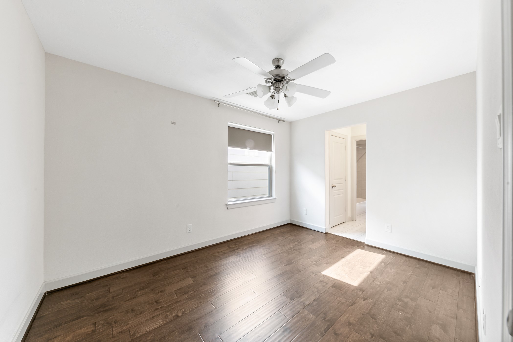 1809 Wichita Street Houston, TX 77004 - Photo 23 of 32 a view of an empty room with wooden floor and a window
