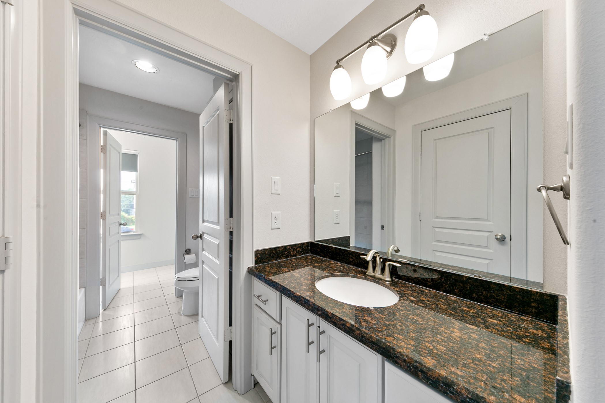 1809 Wichita Street Houston, TX 77004 - Photo 25 of 32 a bathroom with a granite countertop sink and a mirror