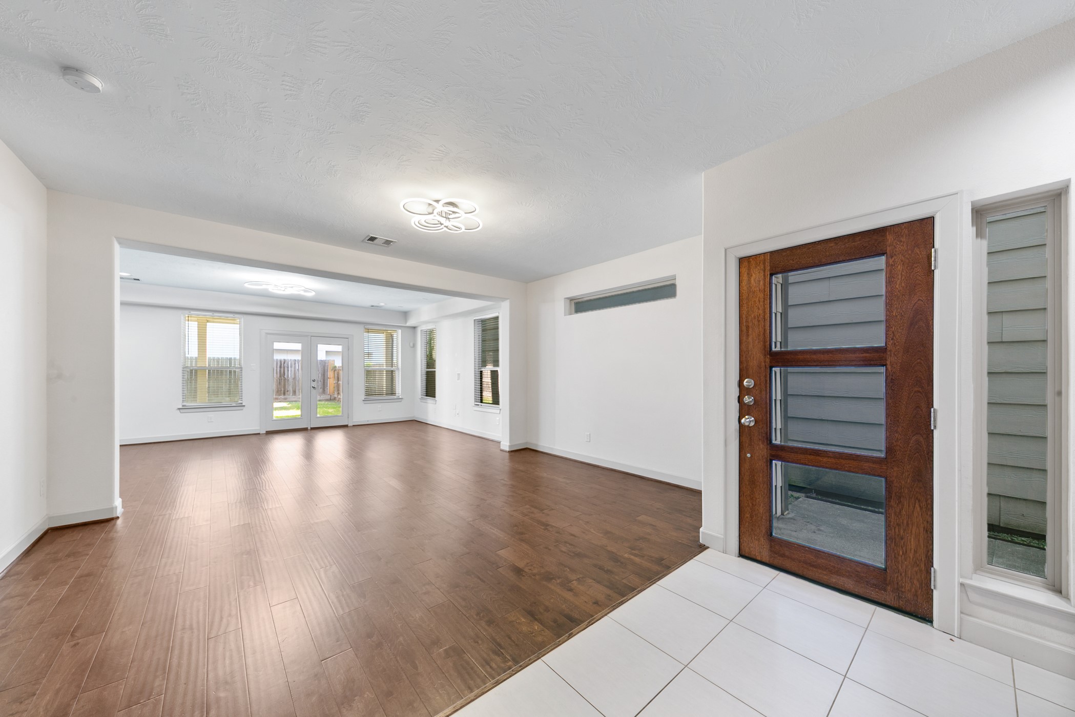 1809 Wichita Street Houston, TX 77004 - Photo 3 of 32 wooden floor in an empty room with a window