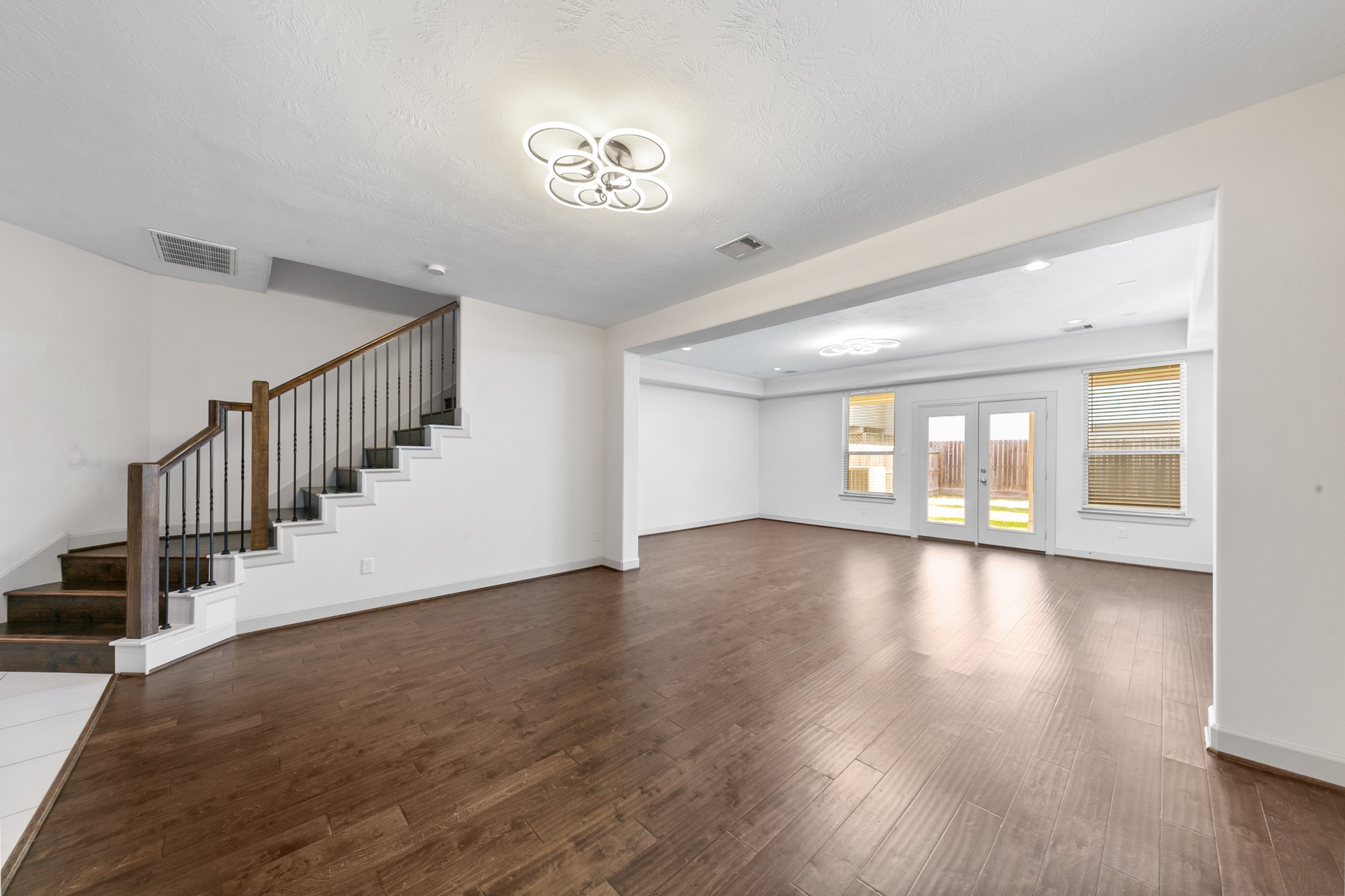 1809 Wichita Street Houston, TX 77004 - Photo 5 of 32 a view of an empty room with wooden floor and stairs
