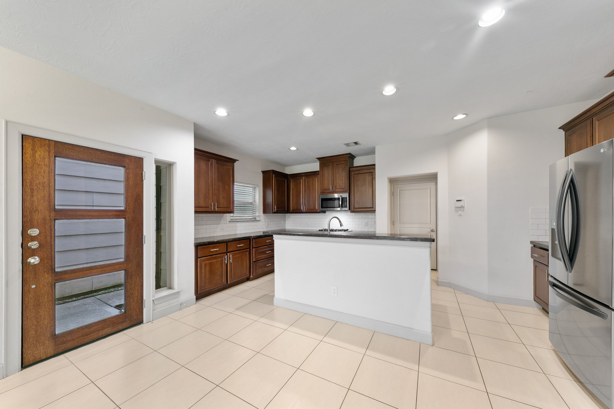 1809 Wichita Street Houston, TX 77004 - Photo 8 of 32 a kitchen with stainless steel appliances granite countertop a refrigerator and a sink