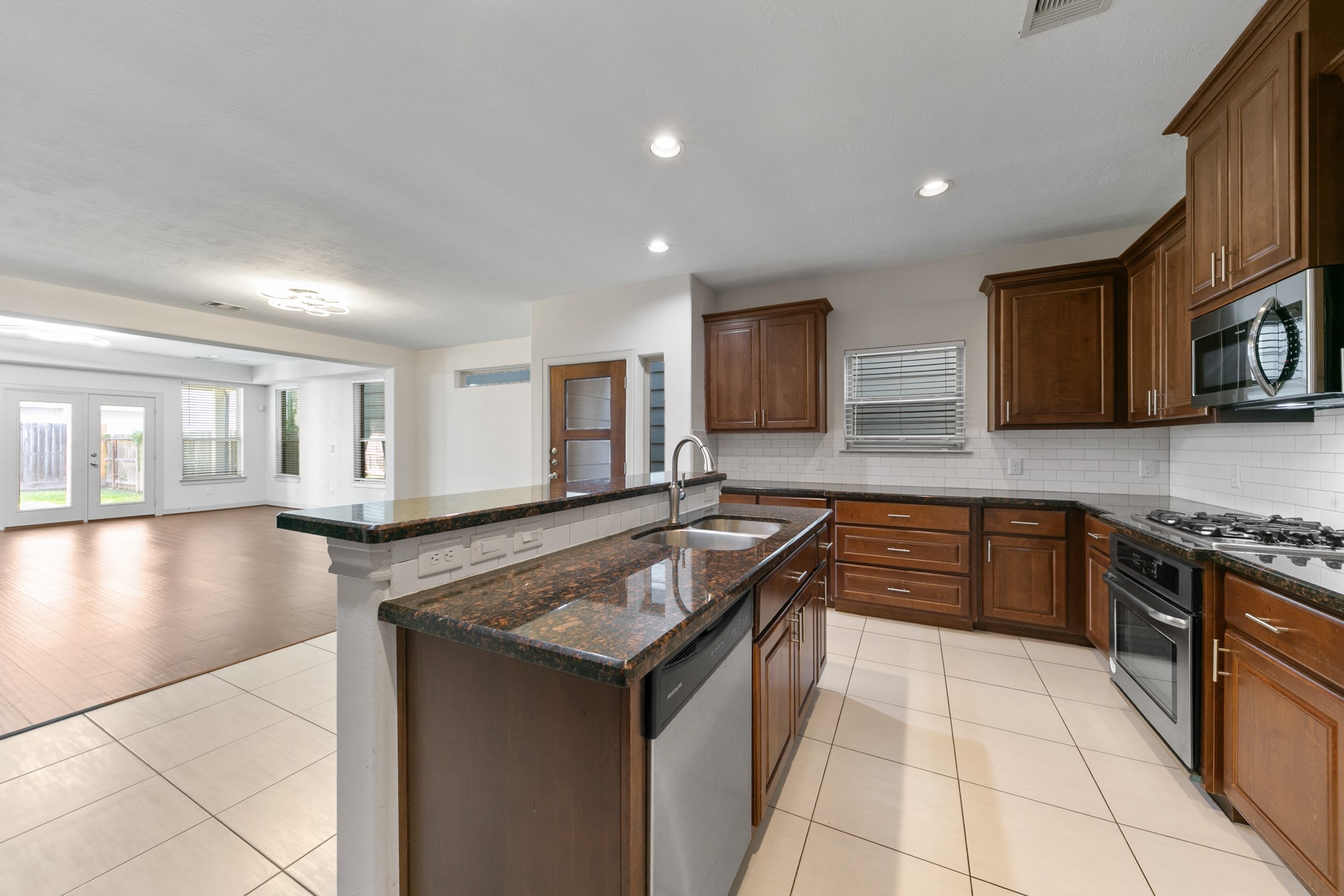 1809 Wichita Street Houston, TX 77004 - Photo 9 of 32 a kitchen with stainless steel appliances granite countertop a sink stove and cabinets