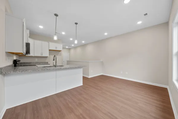 a large kitchen with kitchen island a sink stainless steel appliances and cabinets