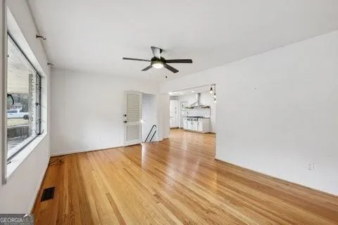 wooden floor in an empty room with a window
