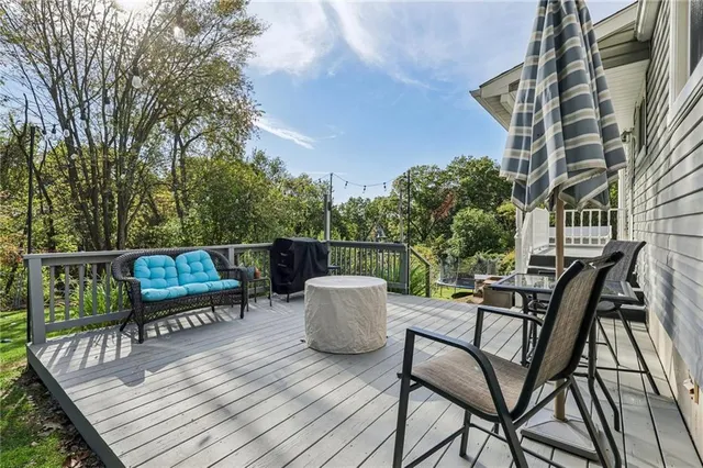 a view of a roof deck with chair and wooden floor