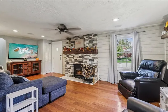 a living room with fireplace furniture and a flat screen tv