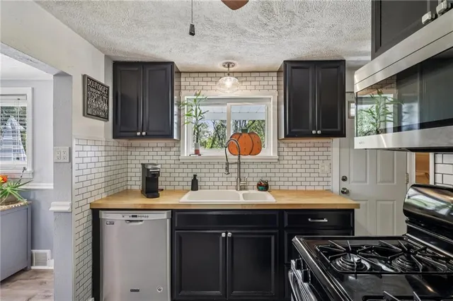 a kitchen with a sink stove and cabinets