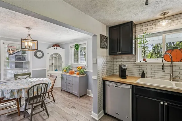 a kitchen with a wooden table and chairs