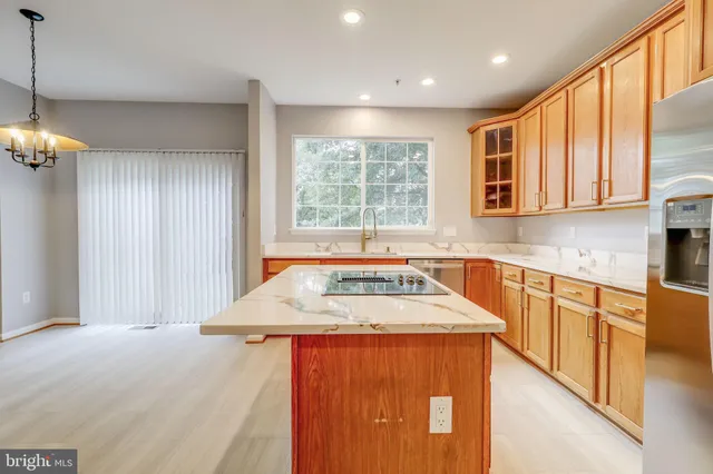 a view of a hallway with wooden floor and stairs