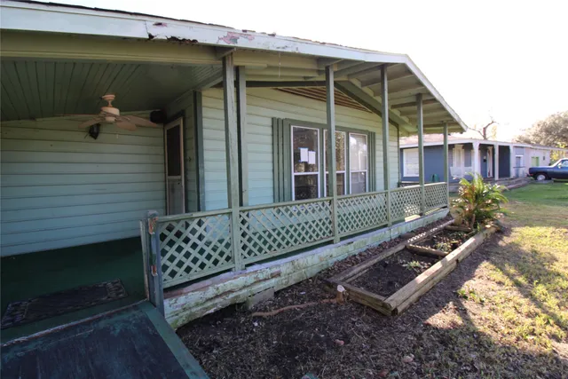 a view of a wooden bench with wooden fence