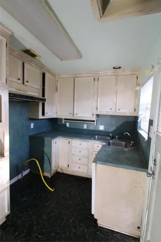 a kitchen with a sink and cabinets