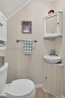 a bathroom with a toilet a sink and mirror