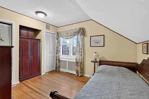 a bedroom with bed and cabinets