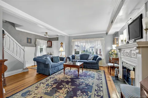 a living room with fireplace furniture and a flat screen tv