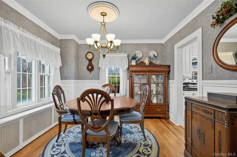 a view of a dining room with furniture wooden floor and chandelier