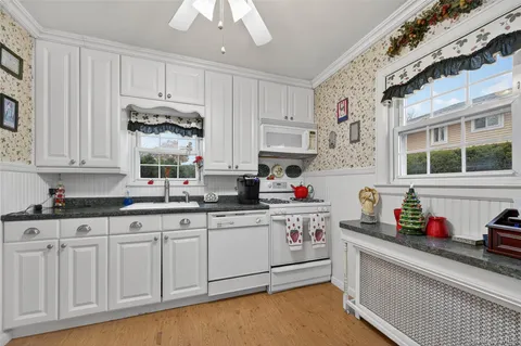 a kitchen with stainless steel appliances granite countertop a sink and cabinets