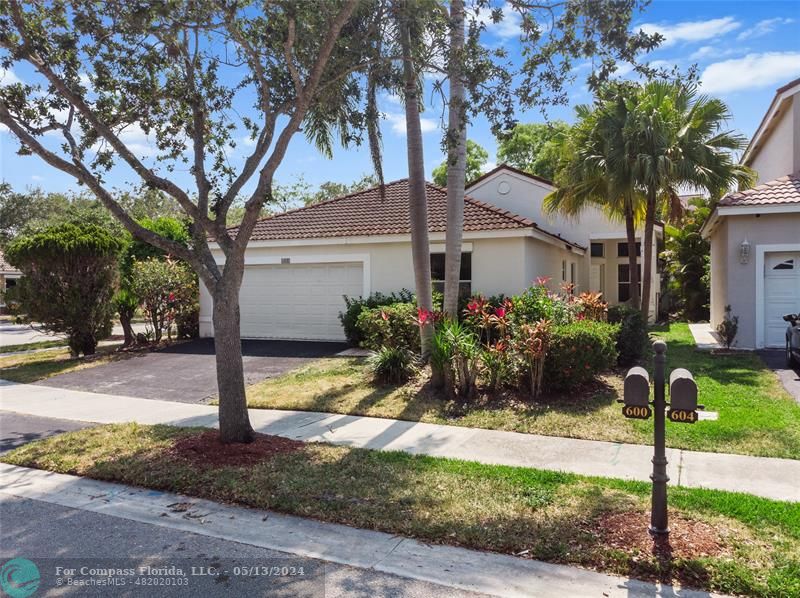600 Stanton Drive Weston, FL 33326 - Photo 2 of 5 a view of a house with small yard plants and a tree