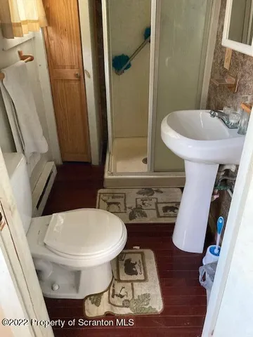 a living room with a couch and a wooden floor