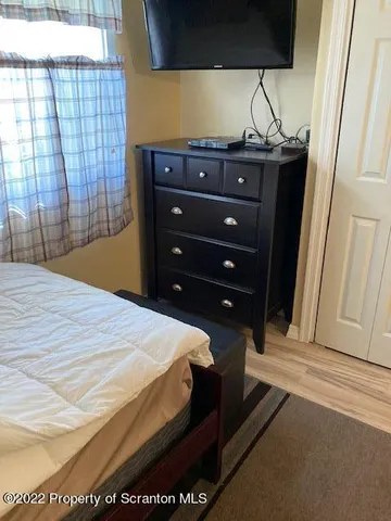 a room with water heater and wooden cabinets
