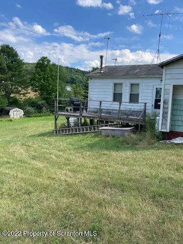 a view of backyard with table and chairs