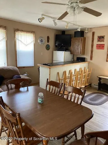 a living room with furniture a table and a large window
