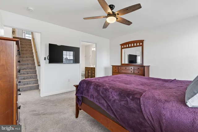 a view of a room with wooden floor furniture and a window