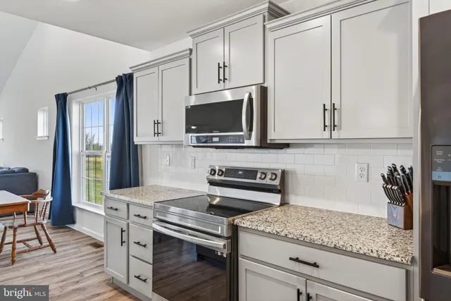 a kitchen with center island table and chairs