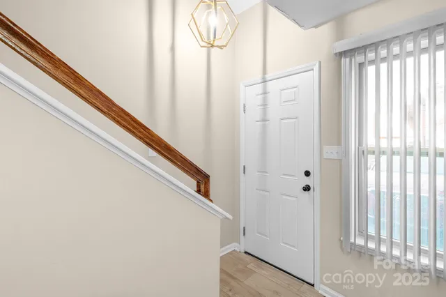 a view of entryway with wooden floor and door