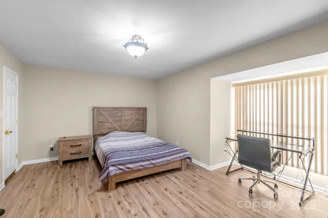 a bedroom with a bed and a chair