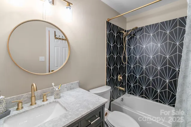 a bathroom with a sink toilet and a mirror