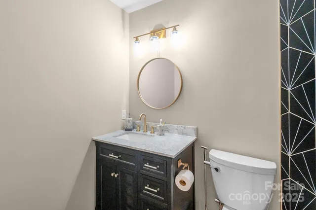 a bathroom with a sink toilet and a mirror