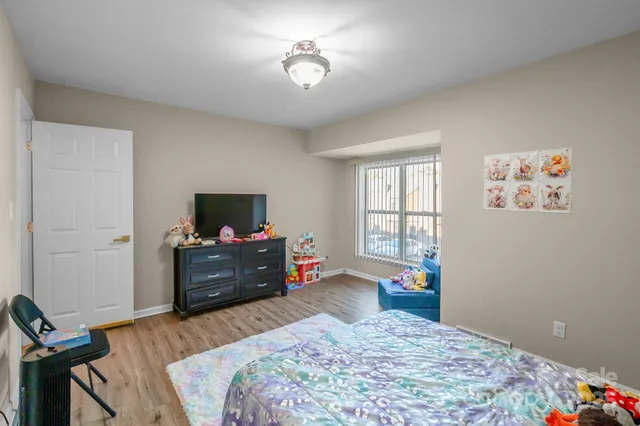 a bedroom with a bed and a chandelier