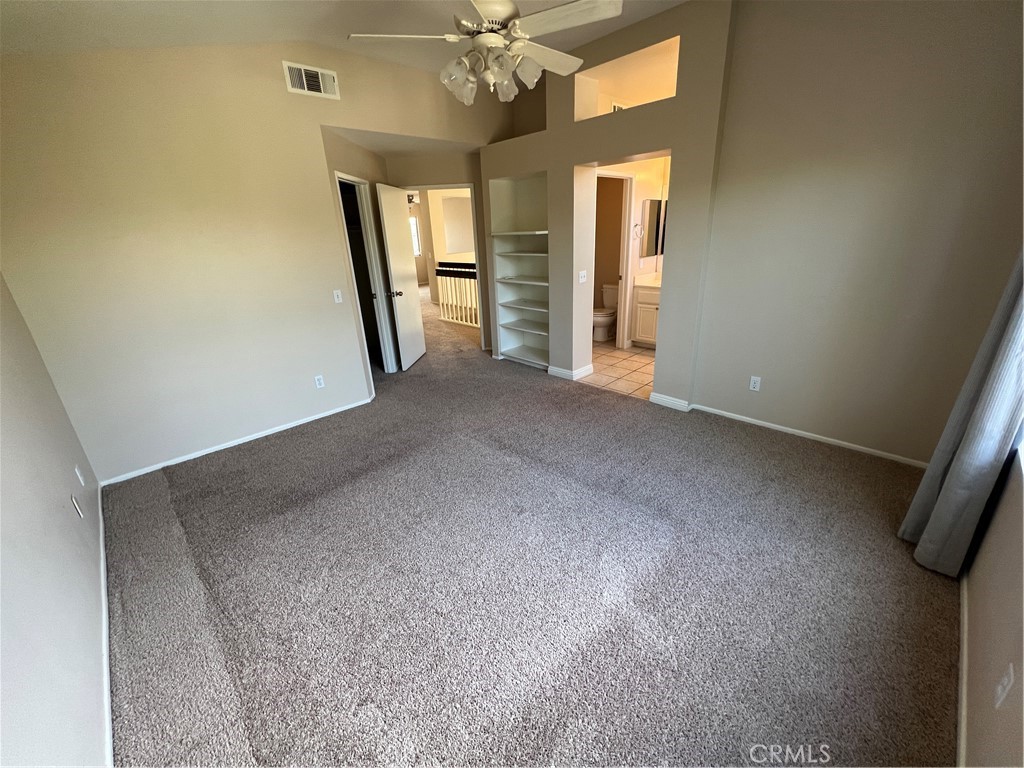 31264 Nice Avenue Mentone, CA 92359 - Photo 14 of 28 an empty room with chandelier fan and windows