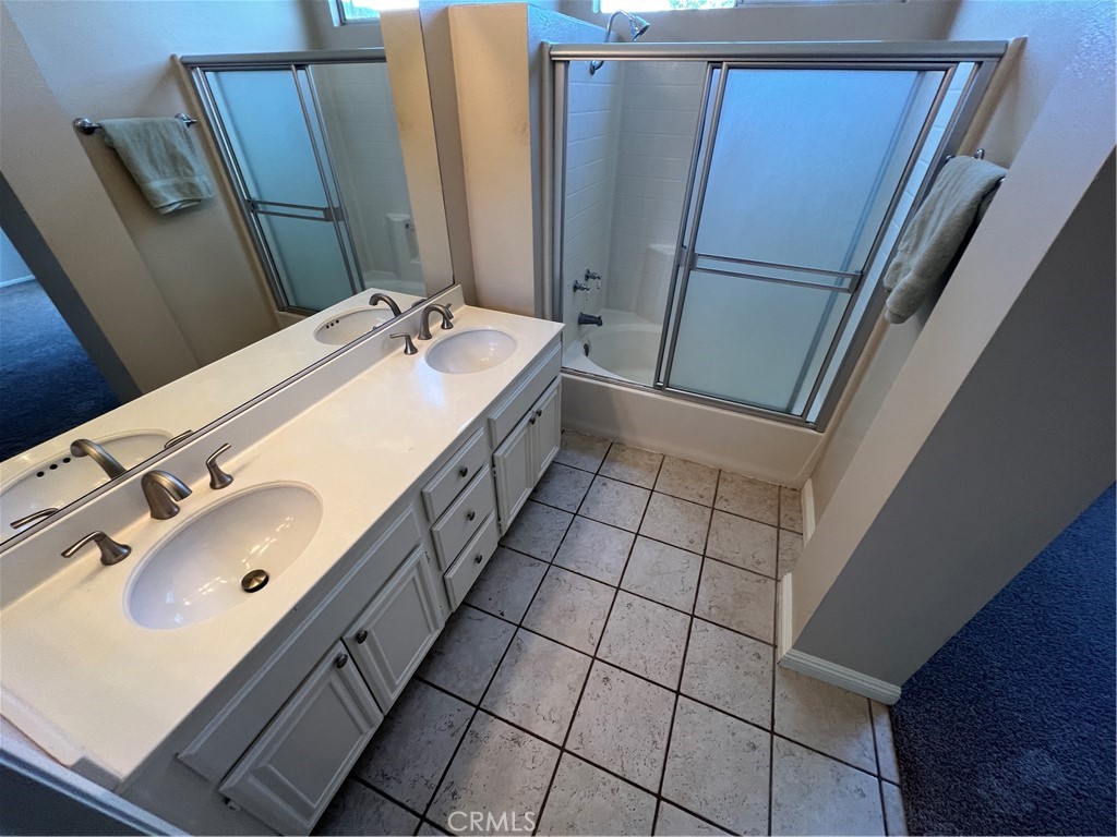 31264 Nice Avenue Mentone, CA 92359 - Photo 16 of 28 a bathroom with a sink and mirror